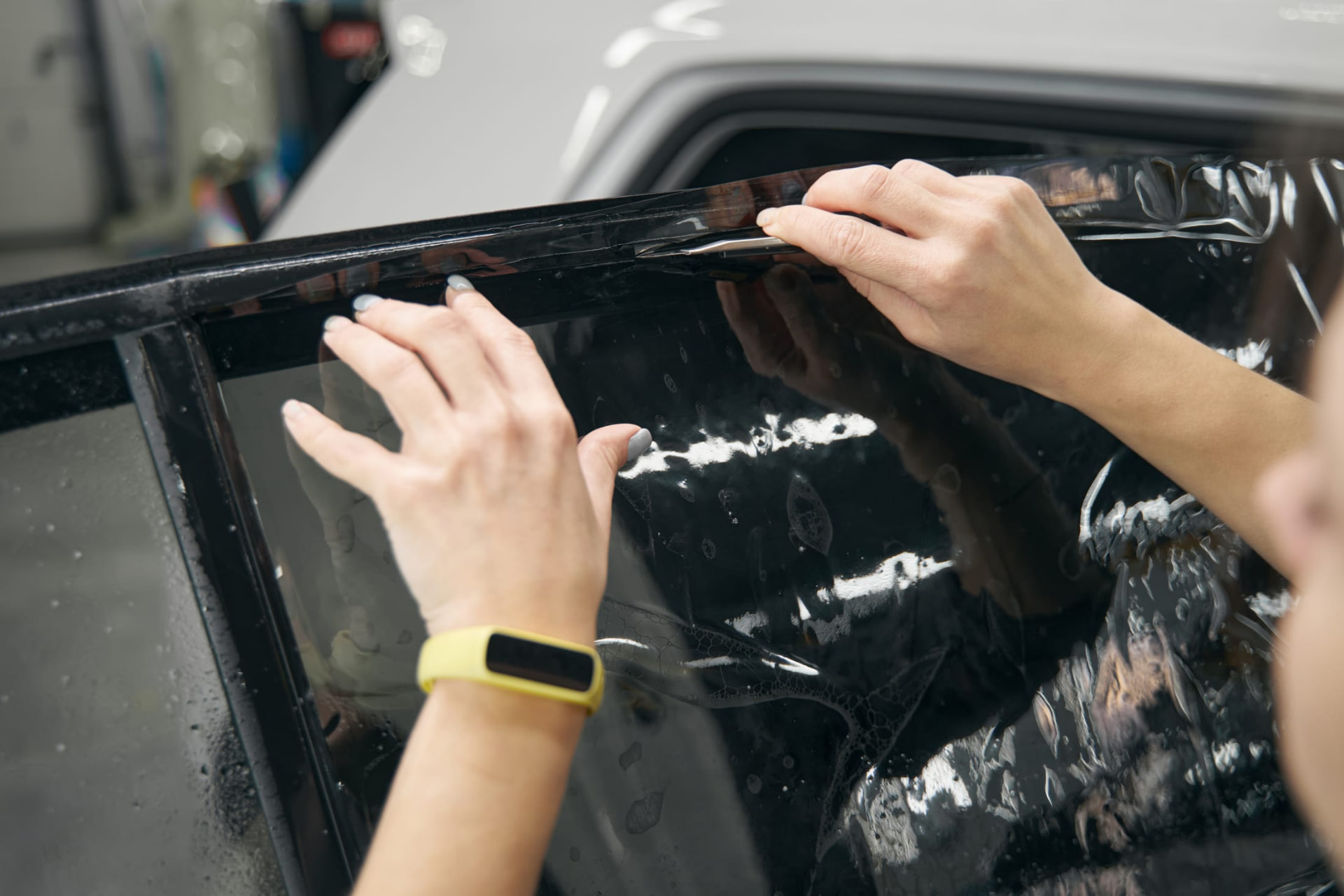 Window tint film being applied to a car door glass